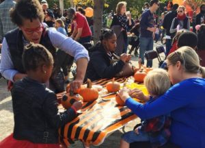 Children decorating pumpkins with their mothers. (Photo: Canal Park)