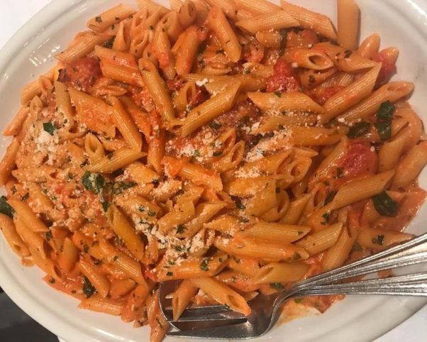A plate of penne a la vodka with a fork and spoon. (Photo: Carmine's)