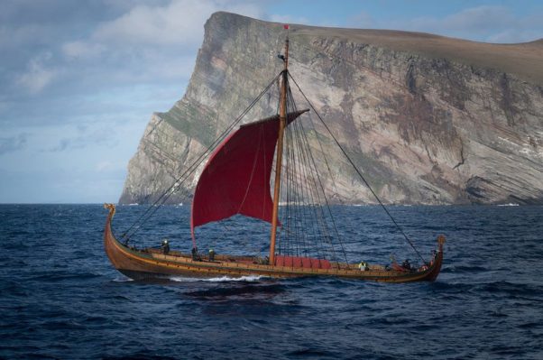 The Viking ship Draken Harald Hårfagre sailing past a cliff. (Photo Viking Nilsson): 