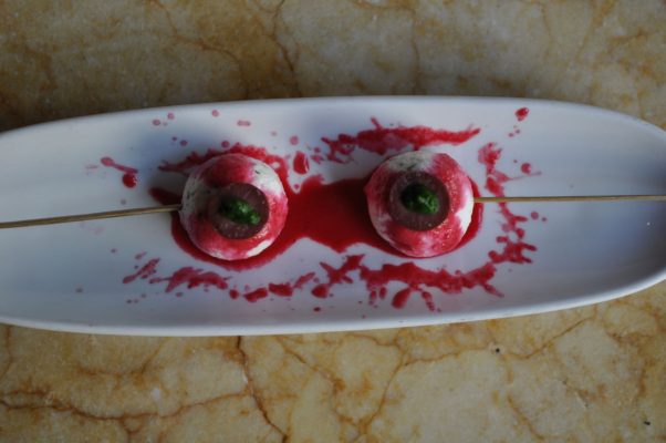 Two vampire bites pintxos that looked like bloody skewered eyeballs” with goat cheese and chives. (Photo: Estadio)