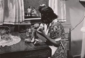 A mother watching her children as she prepares the evening meal in Anacostia's Frederick Douglass housing project in June 1942. (Photo: Gordon Parks)