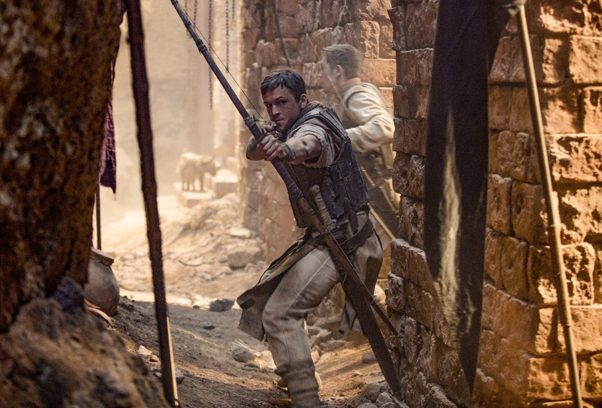 Taron Egerton as Robin Hoot shoots an arrow at the camer. (Photo: Lionsgate Films)