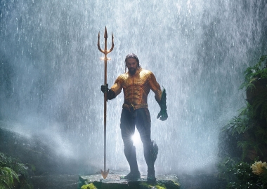 Aquaman stand shirtless with his trident. (Photo: Warner Bros.)