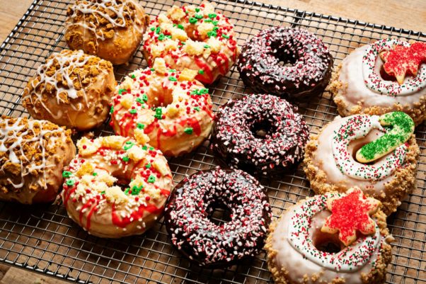 A tray of 12 doughnuts with four rows of three each in gingerbread pear (l to r), cake batter, chocolate candy cane andd Christmas cookie. (Photo: Scott Suchman)