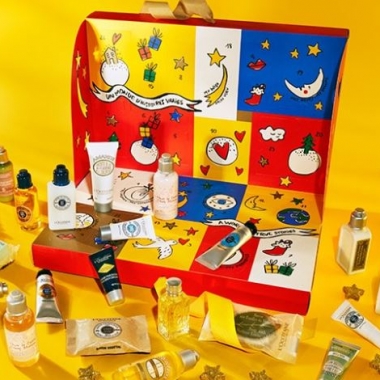 The L'Occitane Signature Advent Calendar box in red, blue and yellow with the enclosed products sitting around it. (Photo: L'Occitane)
