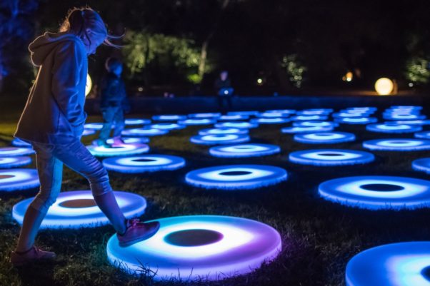 A girl steps on one of the light-up, interactive circular pads from "The Pool" at Yards Park. (Photo: Yards Park)
