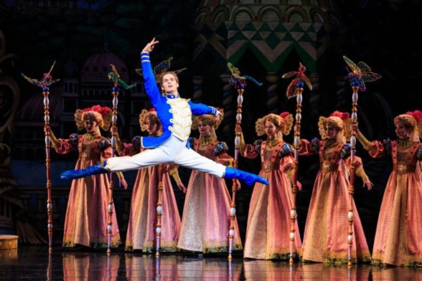 The Nutcracker leaps into the air in front of five women. (Photo: Luke Isley)