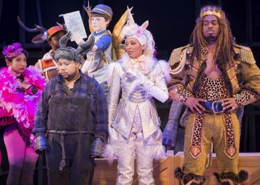 Humans dresses at the donkey (l to r), the unicorn and the lion stand beisde each other in front of a child angle and others. (Photo: Scott Suchman)
