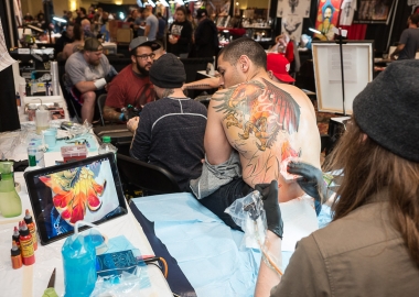 A man getting a large dragon tattooed on his back at the 2016 D.C. Tattoo Expo. (Photo: Mark Van Bergh)