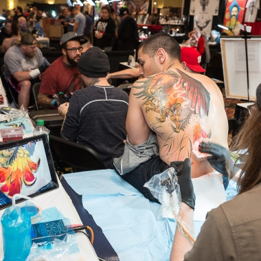 A man getting a large dragon tattooed on his back at the 2016 D.C. Tattoo Expo. (Photo: Mark Van Bergh)