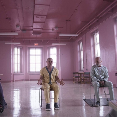 Morgan Freeman, James McAvoy and Bruce Willis sit chained in their chairs in a mental hospital. (Photo: Universal Pictures)