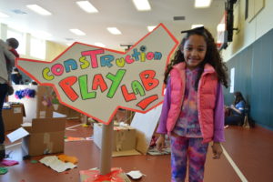 A girl standing in the Construction Play Lab. (Photo: Arlington County Park & Recreation Department)