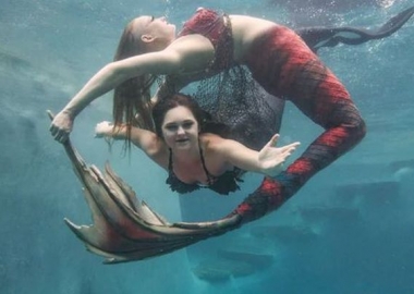 Two mermaids swim underwater. (Photo: Melanie Canatella)