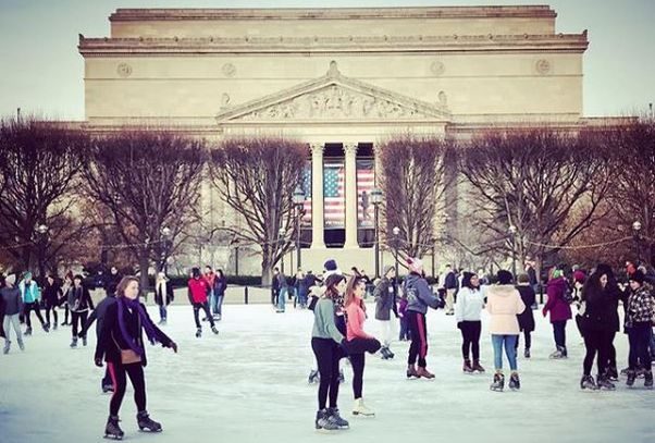 Skaters on the ice at the Natural Gallery of Art Sculpture Garden ice rink with the National Archives in the background. (Photo: louisedettman/Instagram)