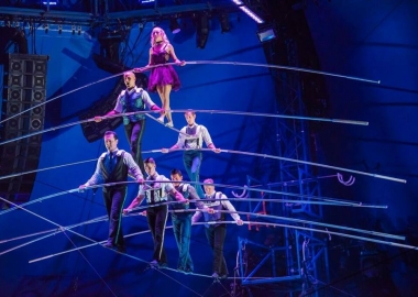 Seven tight rope walkers walk in pyramid formation balancing on each other across the tight rope. (Photo: Big Apple Circus)