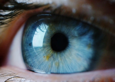 A close-up of a blue eye with flecks of green in it. (Photo: Shutterstock)