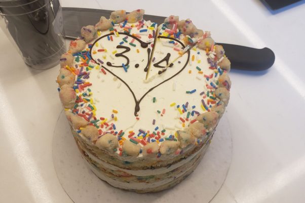 A Milk Bar birthday cake decorated with a heart on top and 3.14 inside the heart. (Photo: Mark Heckathorn/DC on Heels)