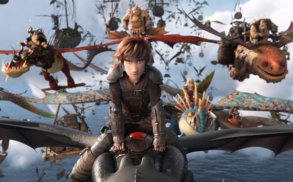 Hiccup flys Toothless into battle with the rest of his vikings fly behind. (Photo: Universal PIctures)