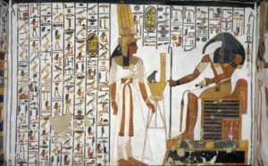 An egyptian painting with Nefertari standing in front of a god with a bird head. (Photo: De-Agostini)
