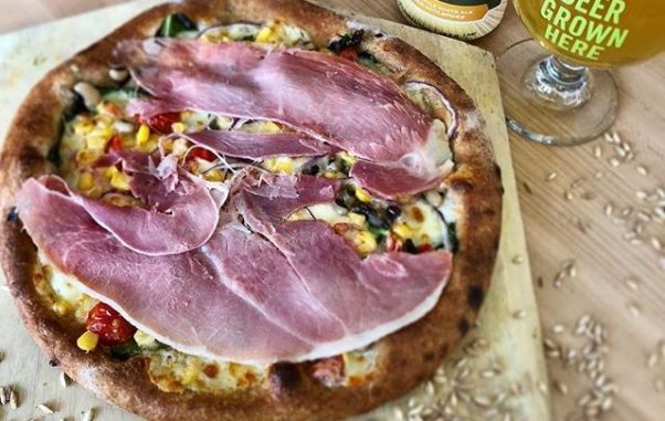 Pizzeria Paradiso's Virginia Pizza with Virginia country ham, cheddar cheese, cherry tomatoes, creamed corn, black eyed peas, collard greens and onions to She Should Run on Friday in observance of International Women's Day. (Photo: Pizzeria Paradiso)