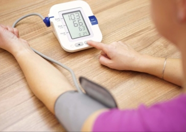 A woman taking her blood pressure with a digital readout. (Photo: iStock Photo)