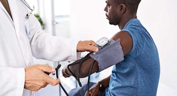 African American man having his blood pressure taken by a doctor. (Photo: Shutterstock)
