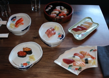 several different kinds of sushi displayed on plates on a table. (Photo: Mark Heckathorn/DC on Heels)