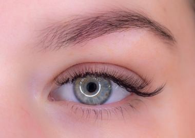 A close up of a green eye with long, thick lashes. (Photo: The Lash Spa)