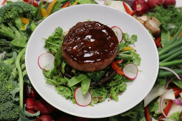 Zinburger's Beyond Burger Vegan Bowl with the vegan patty on top of a bed of baby arugula, red quinoa, radish, grilled Portobello mushrooms and stir-fried vegetables and is topped with lemon vinaigrette, tamari glaze and scallions. (Photo: Zinburger)