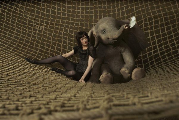 Collette (Eva Green) sitting with a baby Dumbo in a trapeeze net. (Photo: Walt Disney Studios)