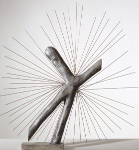 A sculpture by Enrico David that loks like a bent cross with rays coming out of it. (Photo: Hirshhorn Museum)
