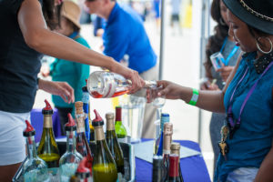 A vendor pours a sample of wine into a visitor's glass. (Photo: National Wine & Food Festival)