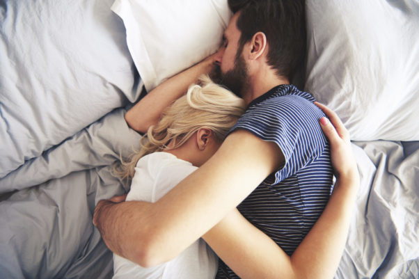 White man and woman holding each other sleeping in bed. (Photo: 123rf)
