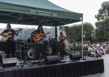 Three musicians perfomring under a canopy in front of the National Gallery of Art's fountain. (Photo: National Gallery of Art)