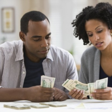 A young black couple counting money. (Photo: Getty ImagesSaving is easier if you do it together. (Photo: money.usnews.com)