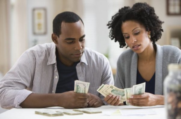 A young black couple counting money. (Photo: Getty ImagesSaving is easier if you do it together. (Photo: money.usnews.com)