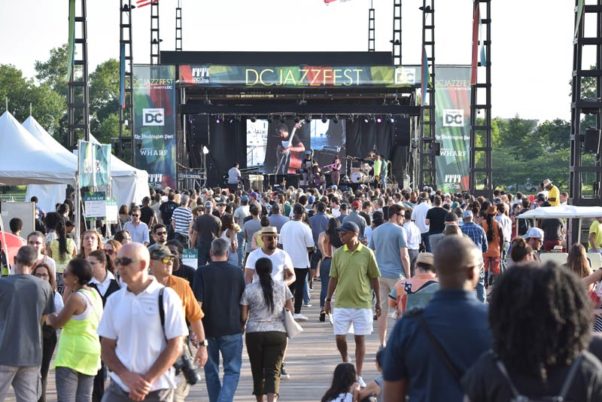 People at the D.C. Jazz Festival walking on a pier at The Wharf in front of the stage. (Photo: D.C. Jazz Festival)