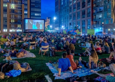 People sitting on blankets watching an outdoor movie in NoMa. (Photo: NoMa BID)