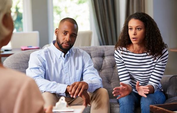 An African-American couple talking to a therapist who has her back to the camera. (Photo: Shutterstock)