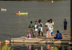 Kids and adults fishing from the Diamond Teague Pier. (Photo: Capitol Riverfront BID)