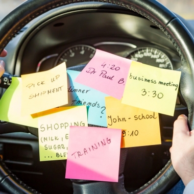 Sticky notes with different reminders stuck on the middle of a steering wheel. (Photo: Shutterstock)