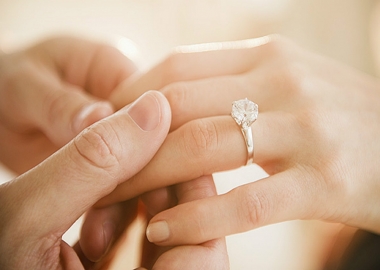 A man's hand holding a woman's hand with an engagement ring on it. (Photo: Getty Images)