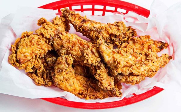 Fried chicken in a red basket with wax paper in it. (Photo: Astro Doughnuts & Fried Chicken)