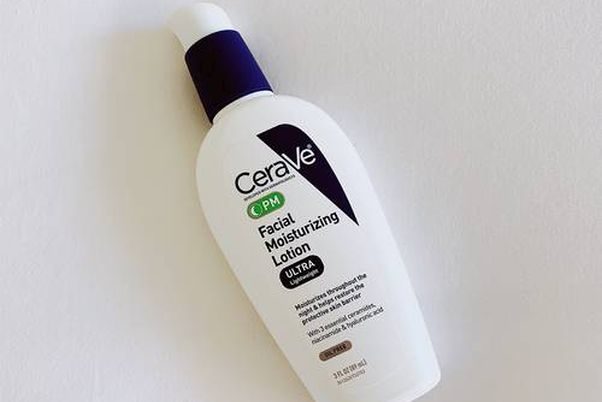 Bottle of CeraVe PM Facial Moisturizing Lotion laying on a counter. (Photo: Danielle Goldmark)