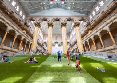 People on the artificial lawn build in the National Building Museum's Great Hall. (Photo: Timothy Schenck/National Buidling Museum)