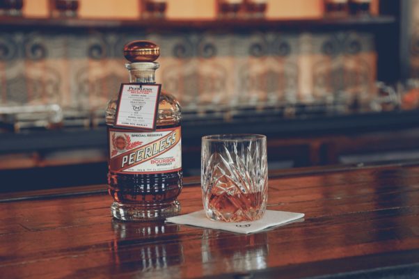 A bottle Kentucky Peerless Distilling Co.’s single barrel bourbon sitting beside a glass of bourbon on a bar. (Photo: Mastro's Steakhouse)