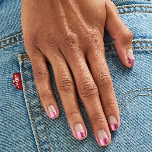 Woman's hand with natural nails with pink metalic tips. (Photo: Paintbox)