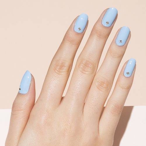 Woman's hand with light sky blue nails, (Photo: Paintbox)