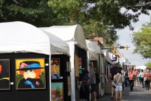 People walking past booths filled with art at the 2018 King Street Art Festival. (Photo: Howard Alan Events)
