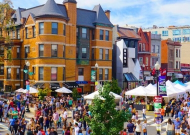 People walking among booths at the Adams Morgan Day Festival. (Photo: Christopher9000/Flickr)